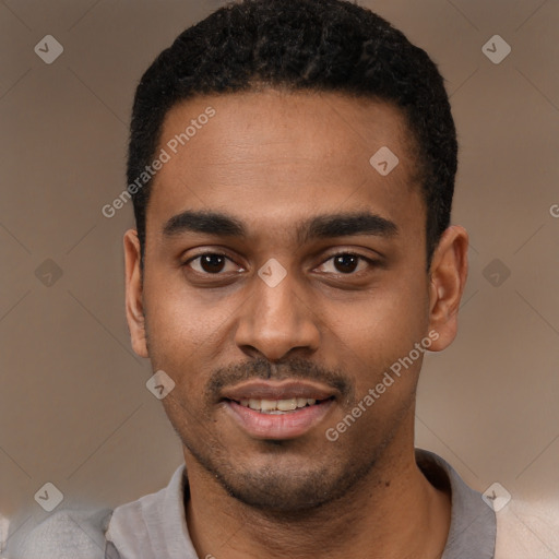 Joyful black young-adult male with short  black hair and brown eyes