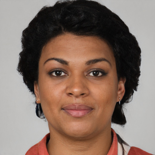Joyful black young-adult female with short  black hair and brown eyes