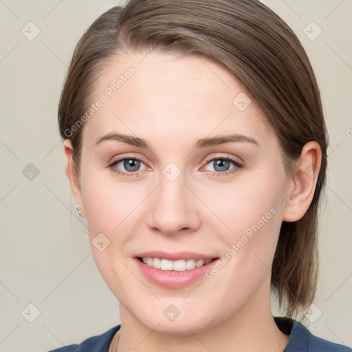 Joyful white young-adult female with medium  brown hair and blue eyes