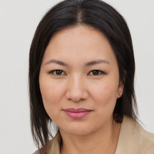 Joyful asian young-adult female with long  brown hair and brown eyes