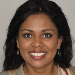 Joyful black young-adult female with medium  brown hair and brown eyes