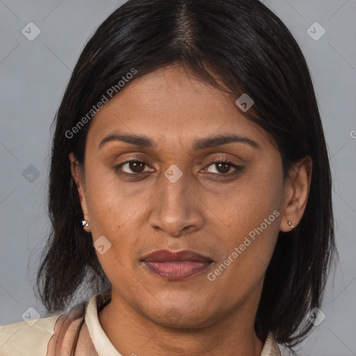 Joyful black adult female with medium  brown hair and brown eyes