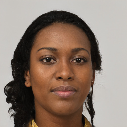 Joyful black young-adult female with long  black hair and brown eyes