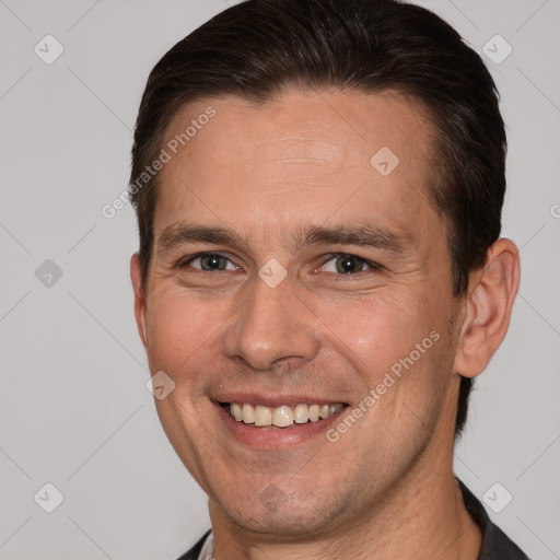 Joyful white adult male with short  brown hair and brown eyes