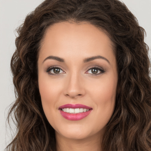 Joyful white young-adult female with long  brown hair and brown eyes