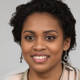 Joyful black young-adult female with long  brown hair and brown eyes