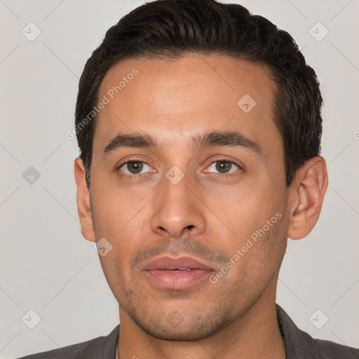 Joyful white young-adult male with short  black hair and brown eyes