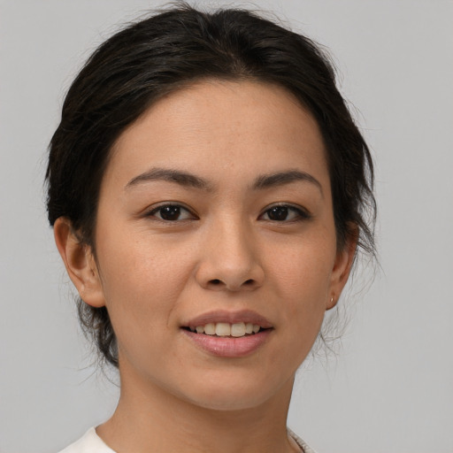 Joyful asian young-adult female with medium  brown hair and brown eyes