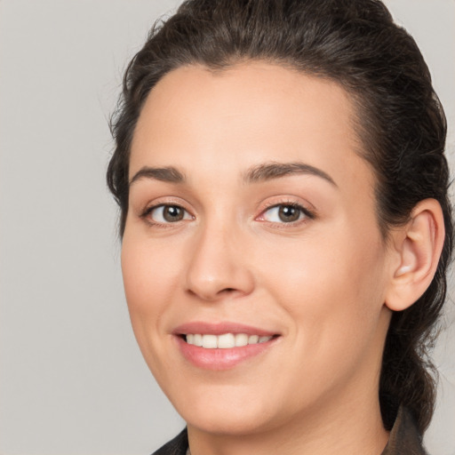 Joyful white young-adult female with medium  brown hair and brown eyes