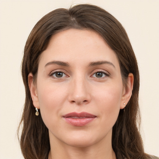 Joyful white young-adult female with long  brown hair and grey eyes