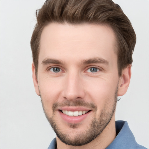 Joyful white young-adult male with short  brown hair and grey eyes