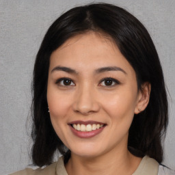 Joyful asian young-adult female with long  brown hair and brown eyes