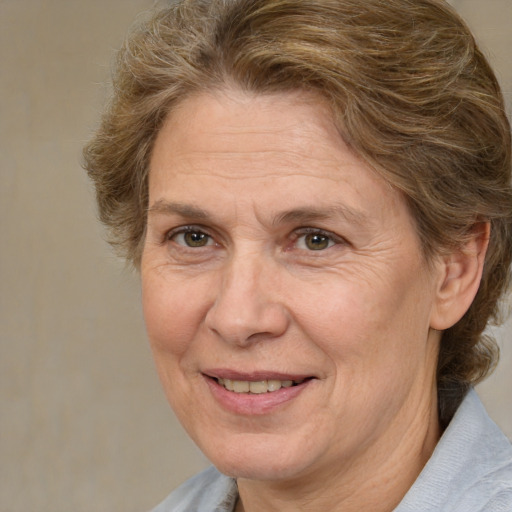 Joyful white middle-aged female with medium  brown hair and brown eyes