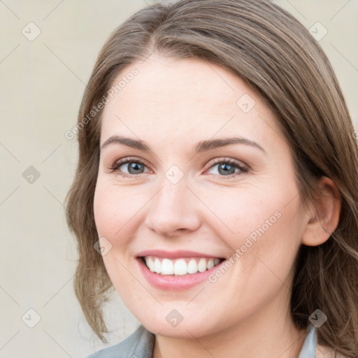 Joyful white young-adult female with medium  brown hair and blue eyes