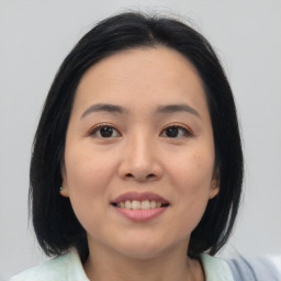 Joyful asian young-adult female with medium  black hair and brown eyes