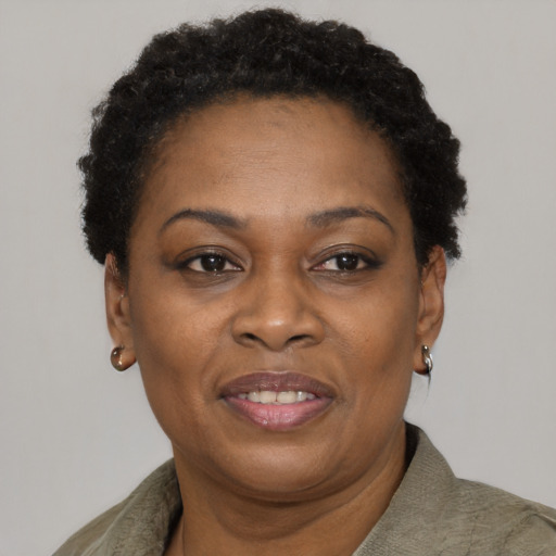 Joyful black adult female with short  brown hair and brown eyes