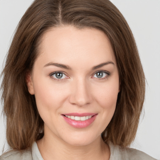 Joyful white young-adult female with medium  brown hair and green eyes