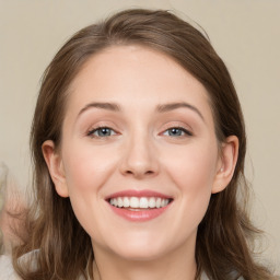 Joyful white young-adult female with medium  brown hair and blue eyes