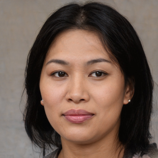 Joyful asian young-adult female with medium  brown hair and brown eyes