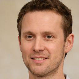 Joyful white adult male with short  brown hair and brown eyes