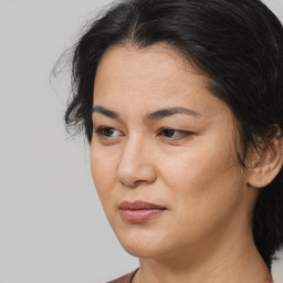 Joyful asian adult female with medium  brown hair and brown eyes