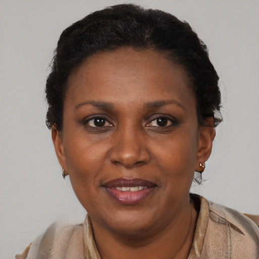 Joyful black adult female with short  brown hair and brown eyes