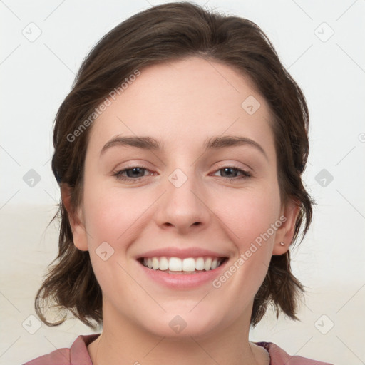 Joyful white young-adult female with medium  brown hair and blue eyes