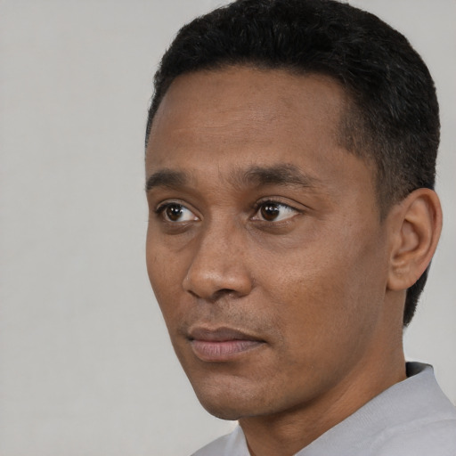 Neutral black adult male with short  black hair and brown eyes