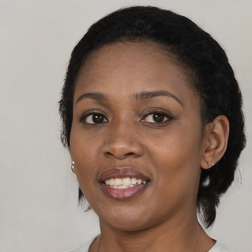 Joyful black young-adult female with medium  black hair and brown eyes