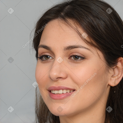 Joyful white young-adult female with long  brown hair and brown eyes