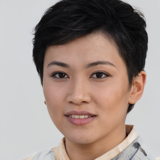 Joyful asian young-adult female with short  brown hair and brown eyes