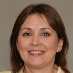 Joyful white adult female with medium  brown hair and brown eyes