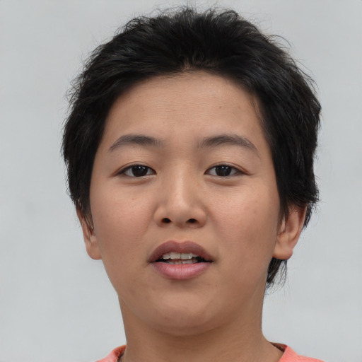 Joyful asian young-adult female with short  brown hair and brown eyes