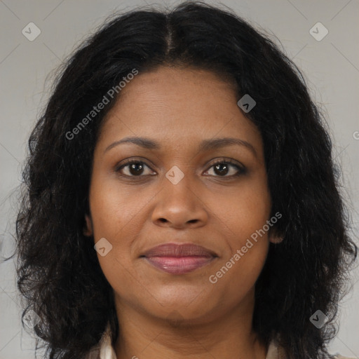 Joyful black young-adult female with long  brown hair and brown eyes