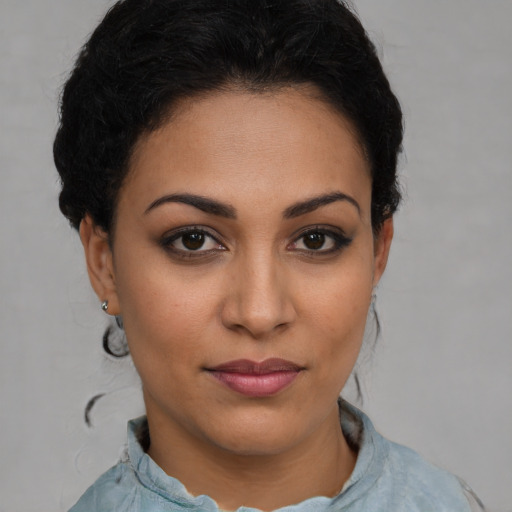 Joyful latino young-adult female with short  brown hair and brown eyes