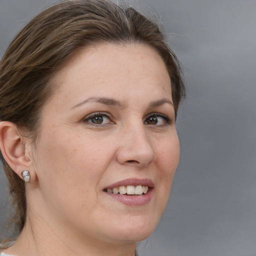 Joyful white adult female with medium  brown hair and brown eyes