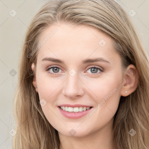 Joyful white young-adult female with long  brown hair and blue eyes