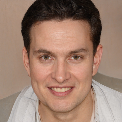 Joyful white adult male with short  brown hair and brown eyes