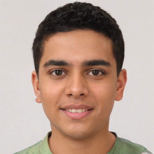 Joyful latino young-adult male with short  brown hair and brown eyes