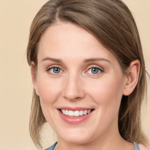 Joyful white young-adult female with medium  brown hair and blue eyes