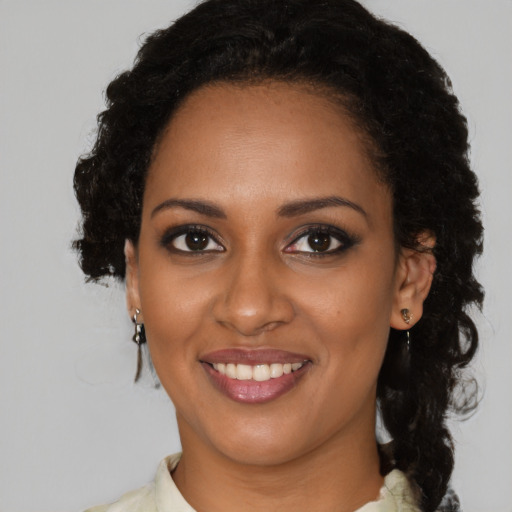 Joyful black young-adult female with medium  brown hair and brown eyes