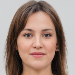 Joyful white young-adult female with long  brown hair and grey eyes