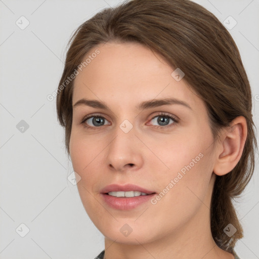 Joyful white young-adult female with medium  brown hair and grey eyes