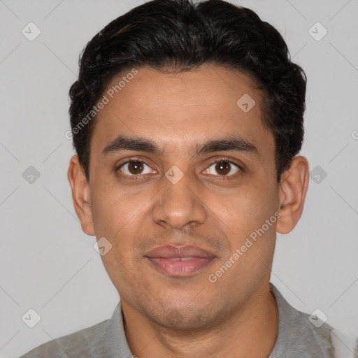 Joyful latino young-adult male with short  black hair and brown eyes