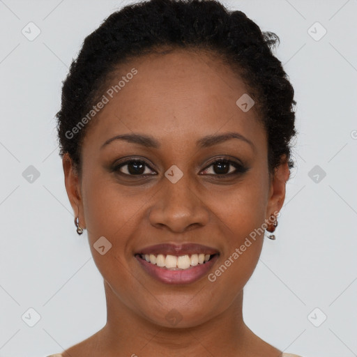 Joyful black young-adult female with short  black hair and brown eyes