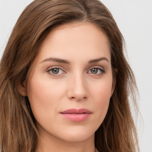 Joyful white young-adult female with long  brown hair and green eyes