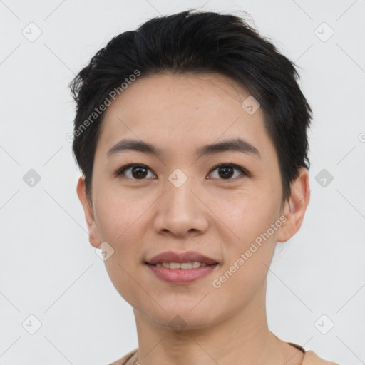 Joyful asian young-adult female with short  black hair and brown eyes