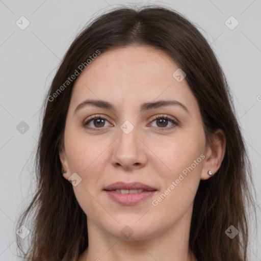 Joyful white adult female with long  brown hair and brown eyes