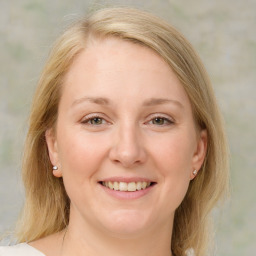 Joyful white young-adult female with medium  brown hair and blue eyes