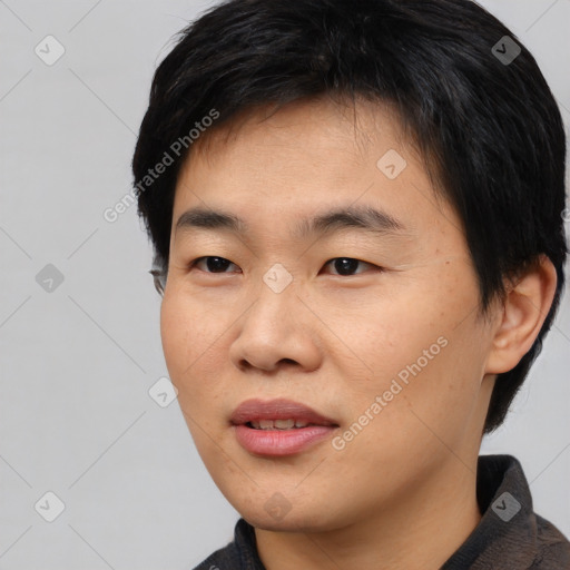 Joyful asian young-adult male with short  black hair and brown eyes